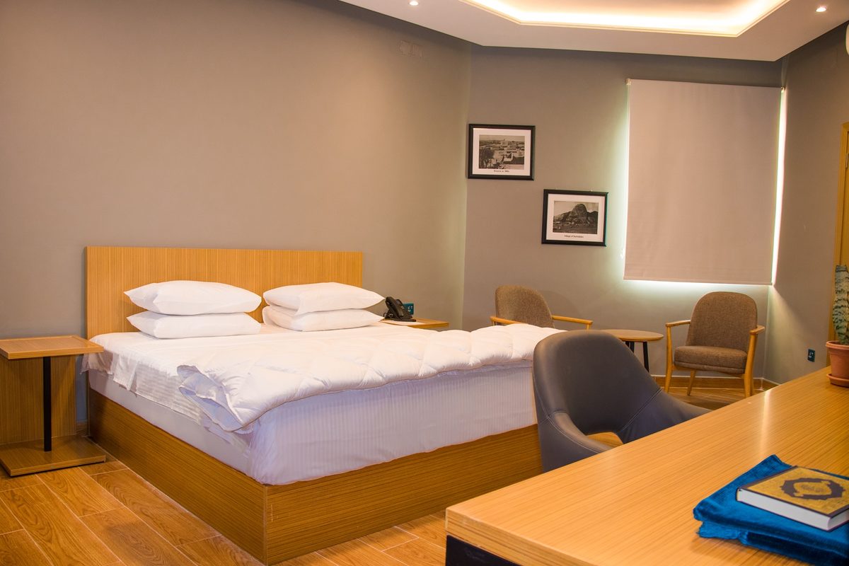 Guest room with double bed, work desk and seating
